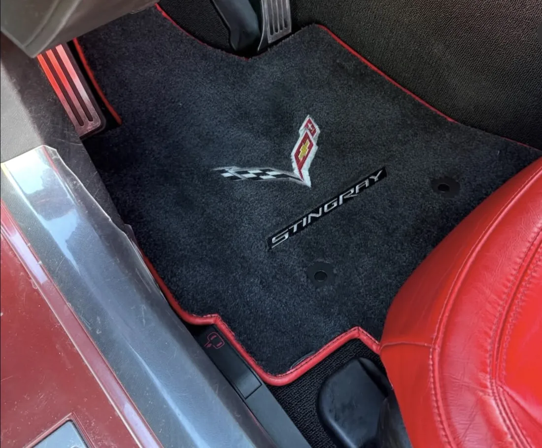 The same footwell after — carpet extracted and the mat back to black