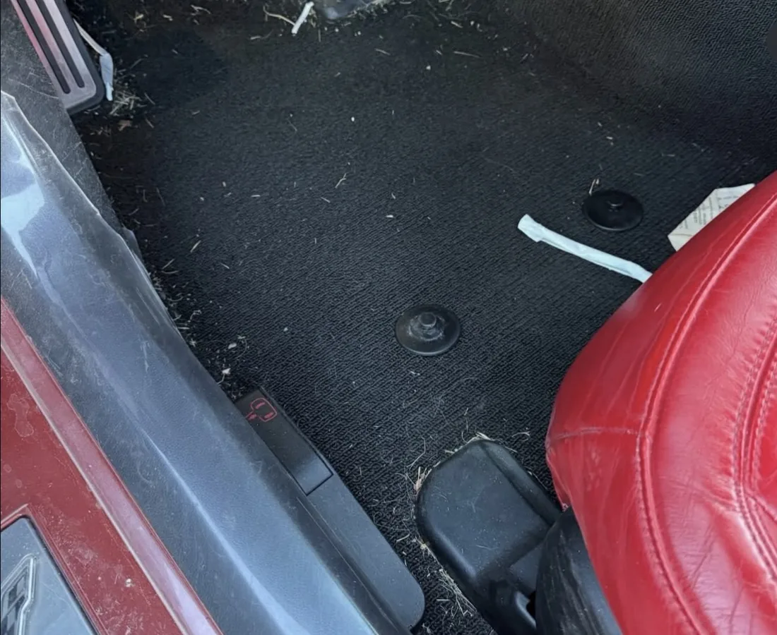 Corvette footwell before — debris and dirt ground into the carpet