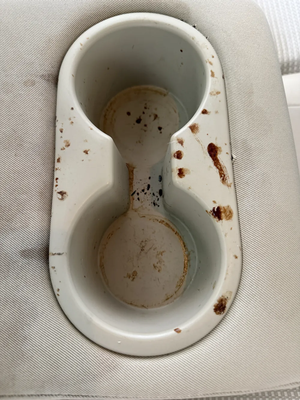 Cup holders before — dried spills and staining